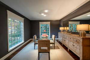 Dining area with plenty of natural light, dark hardwood / wood-style floors, and ornamental molding