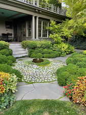 View of yard featuring a balcony and french doors