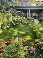 View of yard with a balcony