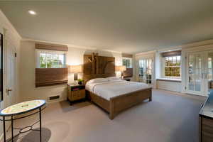 Bedroom with access to exterior, french doors, light colored carpet, and ornamental molding