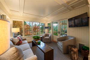 Sunroom / solarium featuring coffered ceiling and french doors