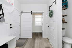 Mudroom featuring a barn door and light hardwood / wood-style floors