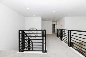 Hallway with light colored carpet