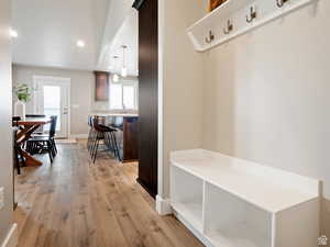 Mudroom with light hardwood / wood-style floors and sink