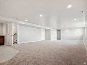 Basement with light colored carpet