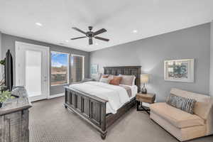 Carpeted bedroom with ceiling fan