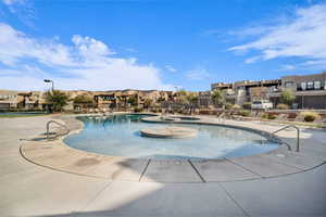 View of pool featuring a patio and a hot tub