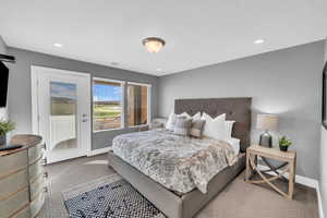 Carpeted bedroom featuring access to exterior