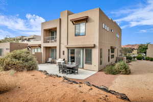 Back of house with a mountain view and a patio