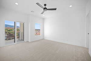 Spare room with light carpet, a mountain view, and ceiling fan