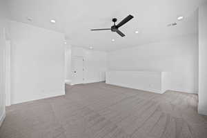 Interior space with ceiling fan and light colored carpet