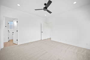 Empty room featuring ceiling fan and light colored carpet