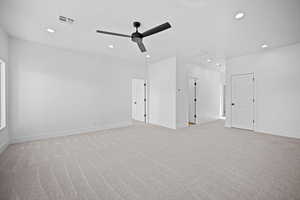 Carpeted spare room with ceiling fan