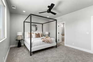 Carpeted bedroom featuring recessed lighting, baseboards, ceiling fan, and ensuite bath