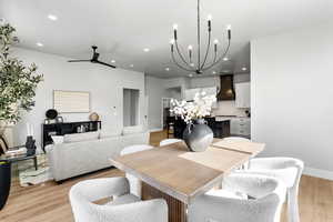 Dining area with a chandelier, recessed lighting, a ceiling fan, light wood-style flooring, and baseboards