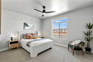 Bedroom with baseboards and light colored carpet