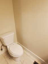 Bathroom featuring tile patterned floors and toilet