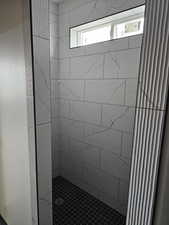 Bathroom featuring tiled shower