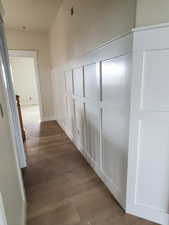 Hallway with dark hardwood / wood-style flooring