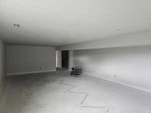 Unfurnished room with a textured ceiling