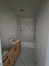 Bathroom with vanity and tiled shower / bath