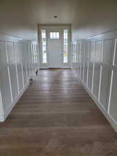 Foyer featuring vaulted ceiling and dark wood-type flooring