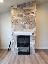 Room details featuring a fireplace and hardwood / wood-style floors