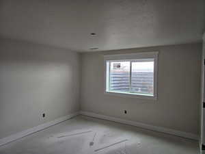 Empty room with a textured ceiling