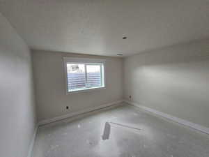 Unfurnished room featuring a textured ceiling