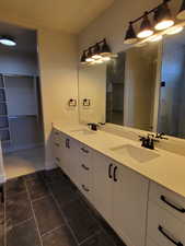 Bathroom featuring tile patterned floors and vanity