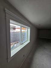 Hallway with concrete flooring and a textured ceiling