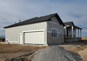 View of side of property with a garage