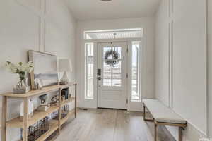 Foyer entrance with light hardwood / wood-style floors