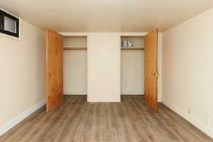 Unfurnished bedroom featuring dark wood-type flooring