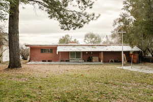 View of rear facade featuring a patio and a back yard