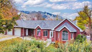 View of front of house featuring a mountain view and a garage