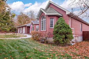 View of home's exterior featuring a garage and a yard