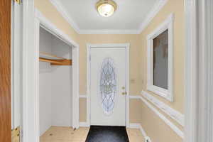 Tiled foyer with ornamental molding