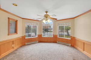 Unfurnished room with light carpet, a baseboard radiator, and crown molding