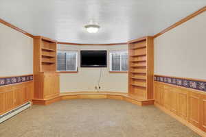 Unfurnished living room with light carpet, a baseboard radiator, a textured ceiling, and ornamental molding