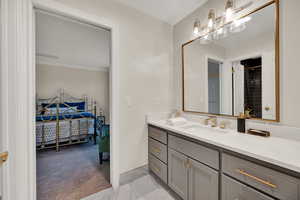 Bathroom with vanity and ornamental molding