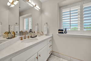 Bathroom with a wealth of natural light and vanity