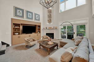 Living room featuring a towering ceiling and a notable chandelier