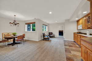 Kitchen featuring hanging light fixtures and a notable chandelier