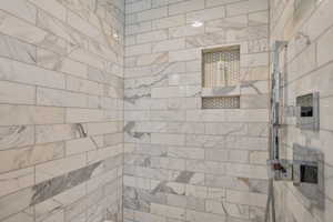 Bathroom featuring tiled shower