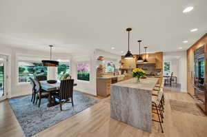 Dining room with light hardwood / wood-style flooring and plenty of natural light