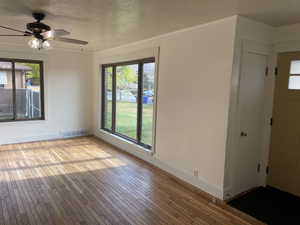 Interior space featuring plenty of natural light, ceiling fan, light wood-type flooring, and crown molding