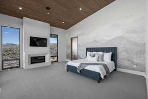 Bedroom with carpet flooring, multiple windows, wood ceiling, and lofted ceiling