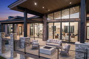 Patio terrace at dusk with outdoor lounge area and french doors