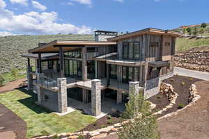 Back of property featuring a balcony and a patio